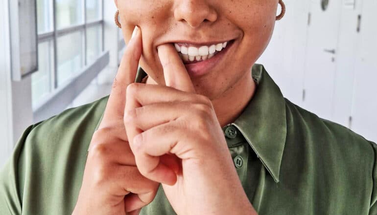 A researcher positions the small suction cup in her cheek.