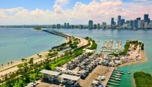 An aerial shot of a marina on Virginia Key, surrounded by water with Miami in the background.