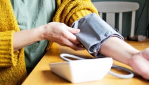 A person uses an at-home blood pressure test.