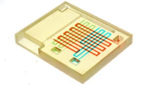 The lab-on-a-chip has several reservoirs and several channels for liquid to flow through.