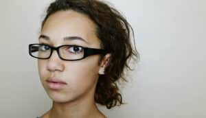 serious teenager looks wary