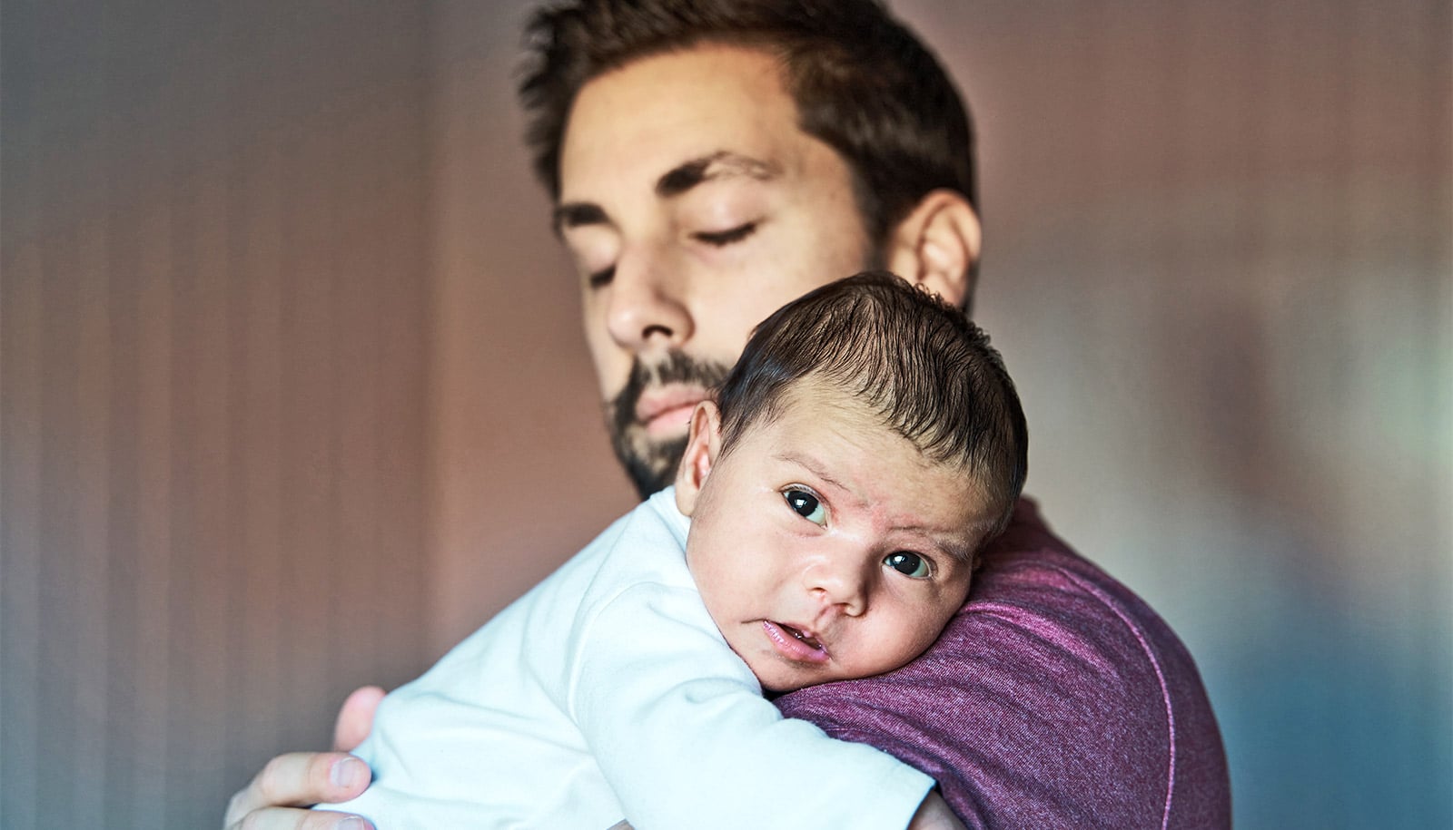 A father holds his baby.