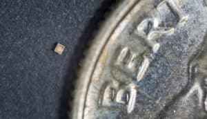 A tiny sensor sits next to a dime that's much, much larger.