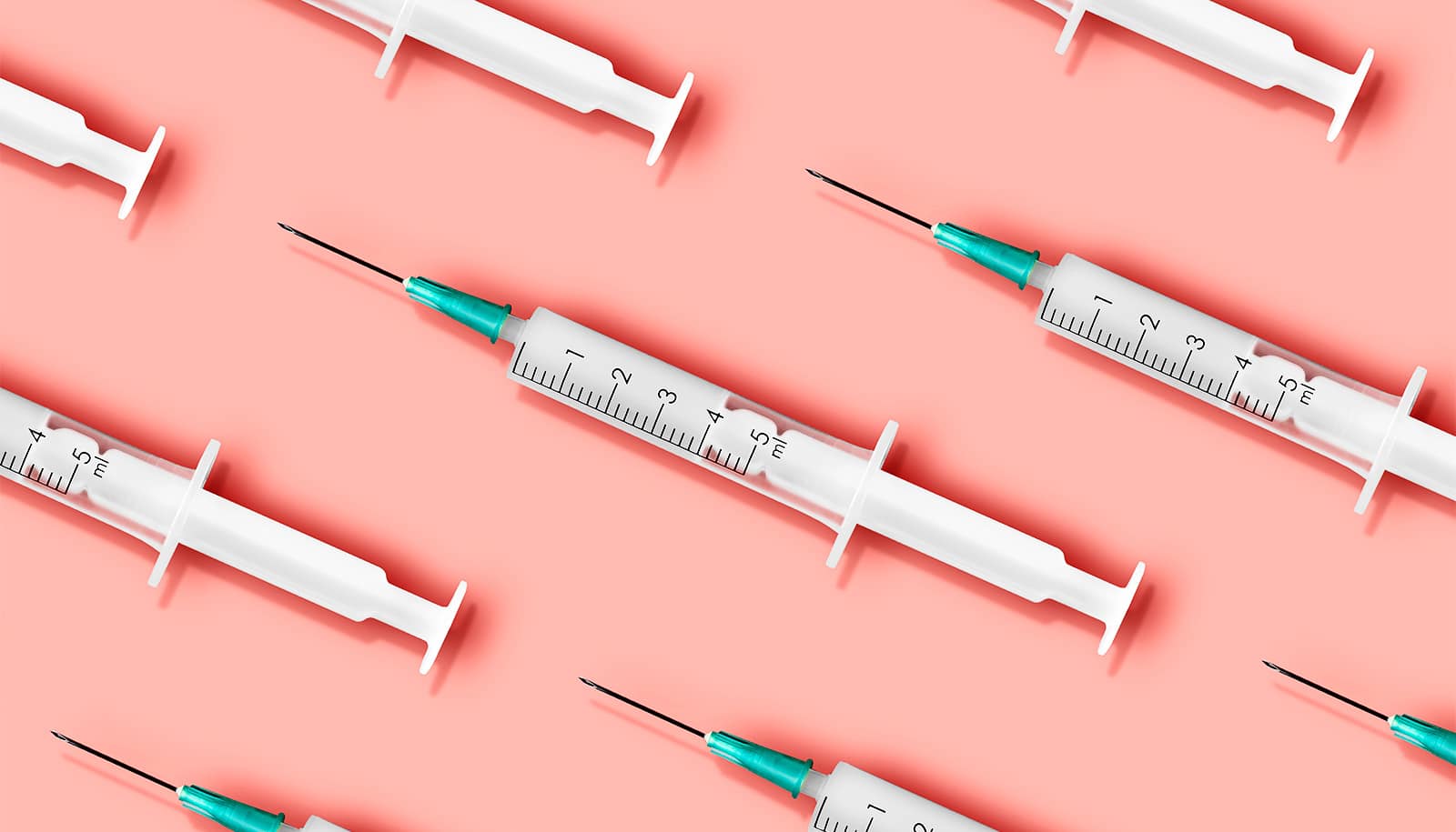 Rows of vaccine syringes on a pink background.