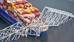 A ship collides with the Francis Scott Key bridge, causing it to collapse into the water.