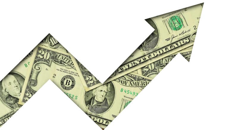 An arrow made of dollar bills points upward.