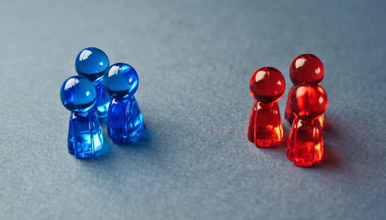 Two groups of three small chess pieces, with one group being blue and the other red.