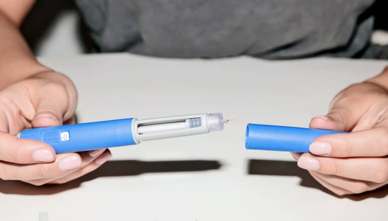 A person opens an injection pen for a new diabetes and obesity drug.
