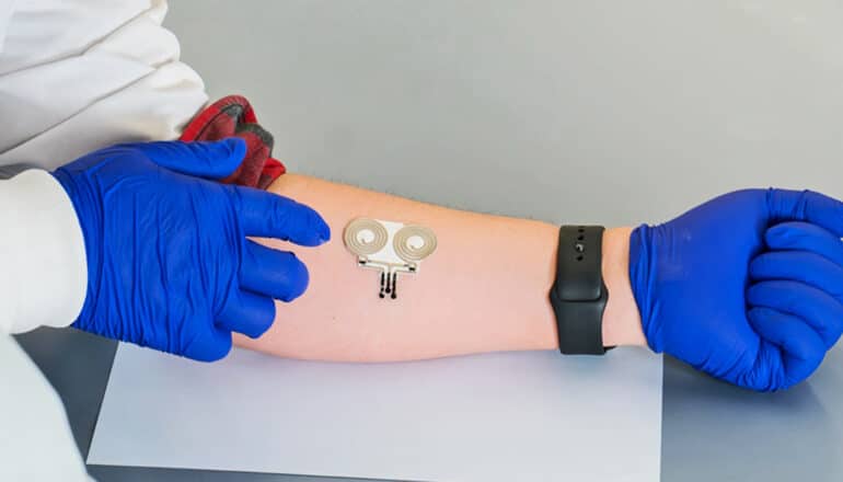 A researcher wears the wearable device on his forearm.