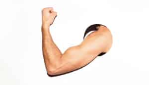 A man's flexing arm sticking through a hole in a white background.