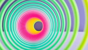 A view through a stretched out Slinky toy looks like a spiral into a hole.