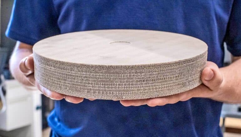 The new 5G antenna is circular and comprised of many different layers of gray material.