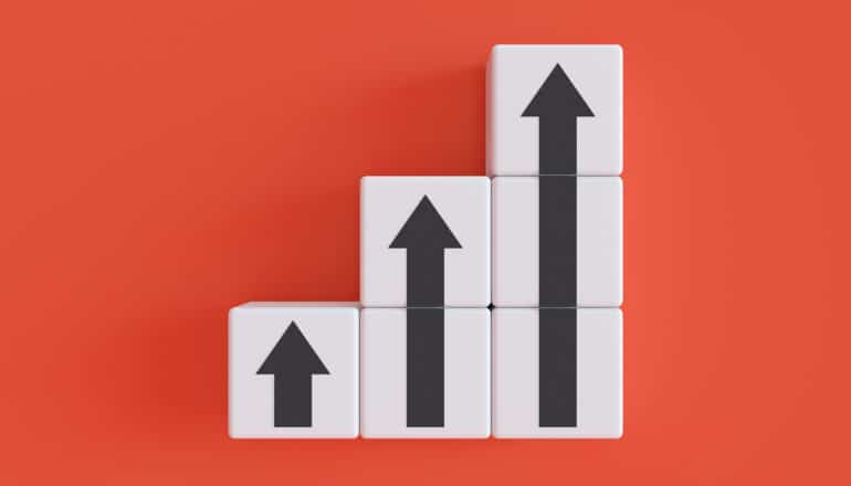Three columns of cubes that get increasingly tall and feature arrows pointing upward.