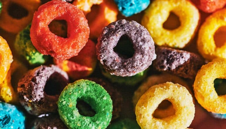 Colorful loops of cereal piled together.