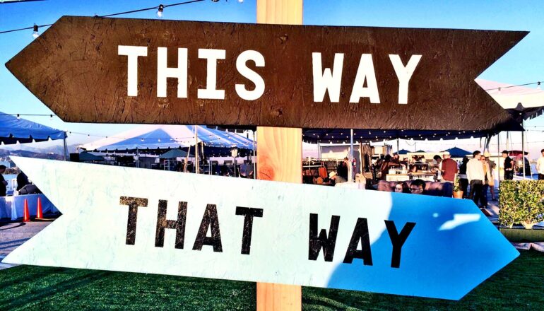 Two signs point in different directions with one labeled 