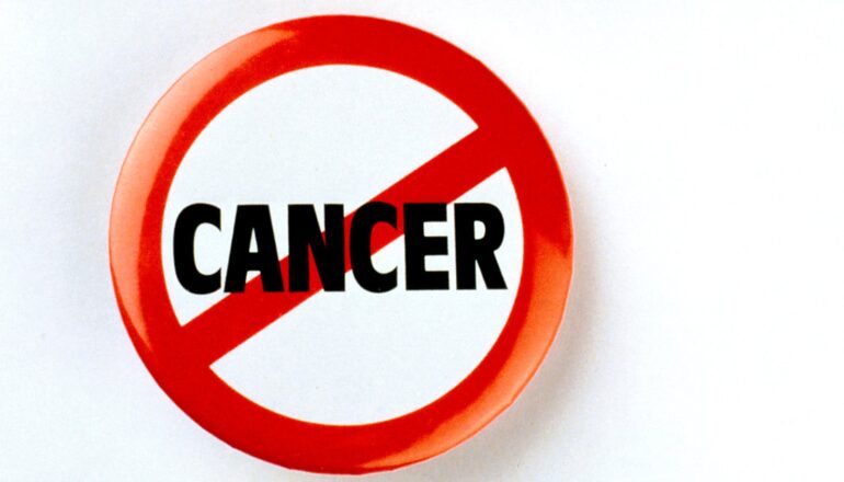 A button with the word "cancer" on it in black text being crossed out by a red line.
