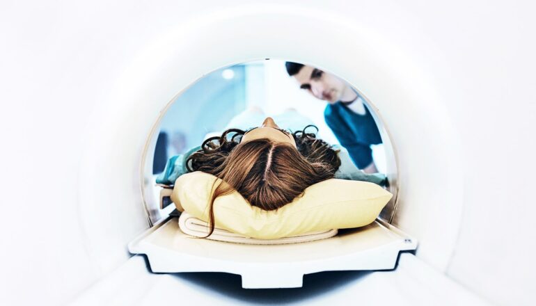 A person is laying on a table about to get an MRI.