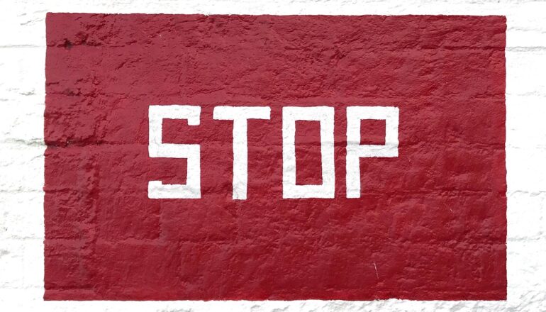 The word "stop" painted in white in a red rectangle.