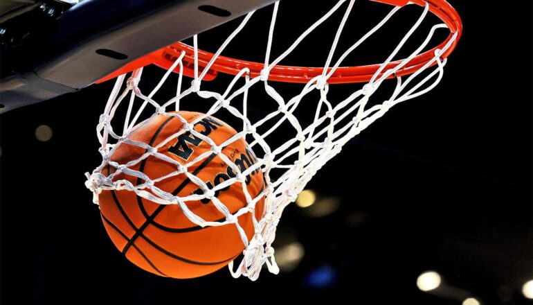 A basketball sails through a hoop.