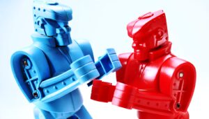 A blue and red toy robot look like they're fighting.