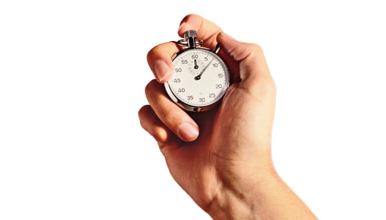 A person holds a stopwatch in their hand.
