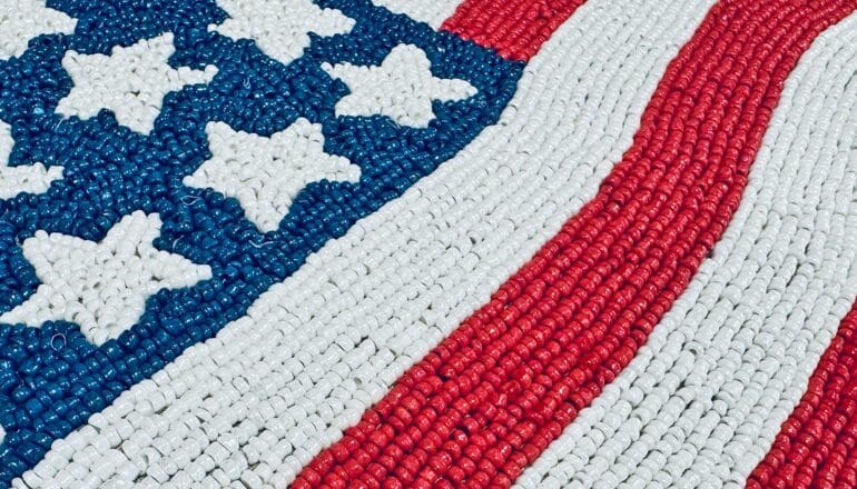 A close-up of a beaded version of the American flag.