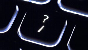 A keyboard key has a question mark on it.