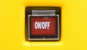 A red "on/off" switch under a clear plastic cover.