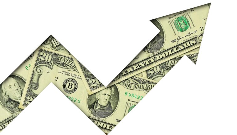 An arrow made of dollar bills points upward.