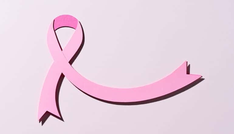 A paper cutout of a pink ribbon.