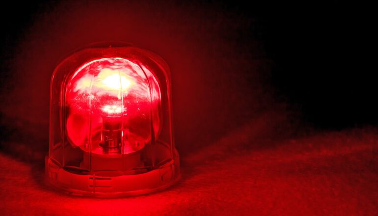 A red warning light flashing in the dark.